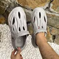Close-up of grey textured outdoor clogs showing breathable design and soft foam material. - 38 / Gray