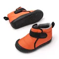 Detail view of orange baby snow boots with anti-slip rubber soles and plush lining - 19 / Orange