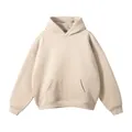 Detailed view of the fabric and design of a beige hoodie with a front kangaroo pocket. - Apricot