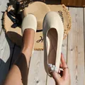 Detail view of breathable beige knit round toe ballet flats with soft cushioned insoles - Off White