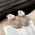 Toddler beige suede snow boots with white fleece lining on a cozy rug detail view - Khaki