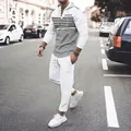 Full body detail of men's waffle knit hooded tracksuit in an urban street setting - S / Top And Bottom / White & Grey Block (White Pants)