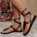 Stylish black flat gladiator sandals with T-strap and ankle wrap buckle design. - 36 / Black