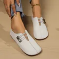 Close-up of elegant white soft leather slip-on loafers with decorative elastic bands - Off White