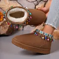 Detailed view of brown snow boots with colorful bead fringes and plush lining - Brown