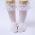 Close-up of white girls' lace ruffle knee-high socks with delicate mesh pattern - One Size (0-8 Years) / Wide Sheer Edge Style / White