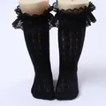 Detailed view of girls black lace ruffled mesh socks with elegant openwork pattern - One Size (0-8 Years) / Wide Sheer Edge Style / Black
