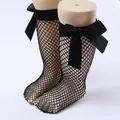 Close-up of black children's fishnet socks with large decorative bows - One Size (0-8 Years) / Bow Fishnet Style / Black