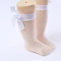 White fishnet mesh socks for girls featuring a delicate white satin ribbon bow detail - One Size (0-8 Years) / Bow Fishnet Style / White