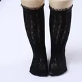 Detailed macro view of black lace mesh knee-high socks for girls with ruffle trim. - One Size (0-8 Years) / Sheer Edge Style / Black