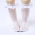 Close-up of white lace ruffle knee-high socks for girls with intricate floral mesh pattern. - One Size (0-8 Years) / Satin Edge Style / White