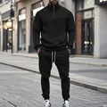 Detail view of black jacquard men's tracksuit set featuring a quarter-zip mock neck - Black