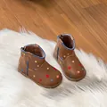 Detailed view of brown toddler boots with colorful star patterns and cozy fur lining. - Brown