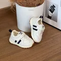 Detailed view of white toddler sneakers with navy stripes, velcro straps and warm lining - 29 / Insole Length 17.5cm / White
