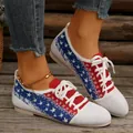Close-up of stylish flyknit flat sneakers with patriotic star pattern and white laces - White