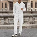 Full view of men's white corduroy casual shirt and pants set on a model outdoors. - White