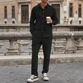 Casual men's black corduroy shirt and pants two-piece set in urban outdoor setting - Black