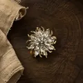 Detailed close-up of an elegant flower brooch with marquise-cut crystals on wood - Flower Rhinestone (Silver) / Silver