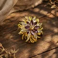 Vintage flower brooch with purple and clear crystals, shown on rustic wooden surface. - Flower Rhinestone (Gold Purple) / Gold Purple