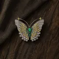 Exquisite detail of elegant butterfly brooch with green, yellow, and white gemstones. - Silver Green Butterfly Style