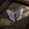 Macro detail of an elegant silver butterfly brooch featuring purple and clear crystals. - Silver Purple Butterfly Style