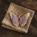Detailed view of an exquisite butterfly brooch with purple and white crystal accents. - Gold Purple Butterfly Style