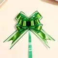 Detailed view of a large green metallic snow yarn pull bow for festive gift wrapping - Pack of 100 / Dark Green