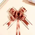 Detail view of a large matte metallic organza bow for gift packaging and decoration - Pack of 100 / Coffee