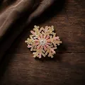 Detailed close-up view of a luxury gold snowflake brooch featuring pink and white crystals - Rotating Snowflake Style (Gold Pink) / Gold Pink