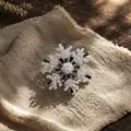 Detailed macro shot of a luxury rotating snowflake brooch with black and clear crystals. - Rotating Snowflake Style (Black) / Black