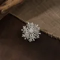 Close-up detail of a luxury rotating snowflake brooch with sparkling clear crystals for coats - Rotating Snowflake Style (Silver) / Silver