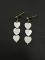 Elegant dangling earrings with triple white shell heart beads and gold plating. - Gold-Spaced Shell Heart Earrings / 1 Pair Pack