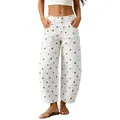 Close-up detail of white women's wide-leg curved jeans with brown polka dot pattern - White
