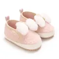 Detailed view of cute pink fuzzy infant crib shoes featuring large white fluffy bows - Pink