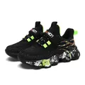 Zapatillas de correr transpirables para niños, tejido negro y suela moteada verde neón - Negro Verde