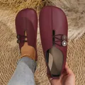 Close-up view of dark red soft leather slip-on shoes with decorative metal buttons - 36 / Casual Flat Shoes (006) / Burgundy