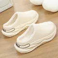 Detailed view of beige fleece-lined platform clogs with plush interior and smile print. - Beige