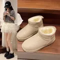 Detailed close-up of warm beige plush-lined winter boots showcased on interior wooden stairs - 36 / Off White