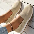 Detailed macro view of breathable fly-knit mesh slip-on casual shoes in beige finish - 36 / Off White