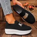Close-up of black knit platform sneakers featuring a stylish gold M metal buckle - 36 / Black