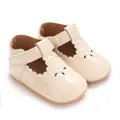 Detail of glossy beige baby Mary Jane shoes featuring scallop edges and a Velcro T-strap - Apricot