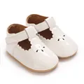 Macro detail of white scalloped baby princess shoes featuring anti-slip rubber soles - White