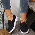 Detail view of women's black knit slip-on sneakers with white platform soles - 35 / Black
