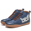 Close-up of blue high-top Martin boots with a cute cat print and brown laces, retro style - 35 / Blue Cat