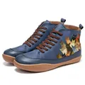 Detail view of vintage blue high-top boots featuring a colorful cat print illustration. - 35 / Blue