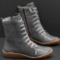 Close-up of grey mid-calf boots with unique horizontal lacing and side zipper. - 35 / Gray
