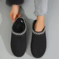 Close-up of women's black plush-lined snow boots featuring silver embroidered trim - 36 / Black