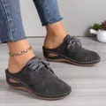 Detailed view of grey lace-up wedge mules with hollow-out patterns and gold anklet. - 36 / Dark Gray