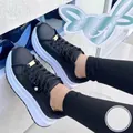Close-up of black platform sneakers with thick white soles and gold accents - 36 / Black