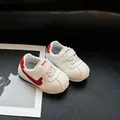 Close-up view of white toddler walking shoes with red swoosh and soft sole - Size 16 (12.5cm) / White